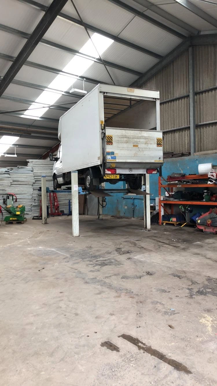 Work van raised on a lift inside the Rhodes Auto Centre workshop